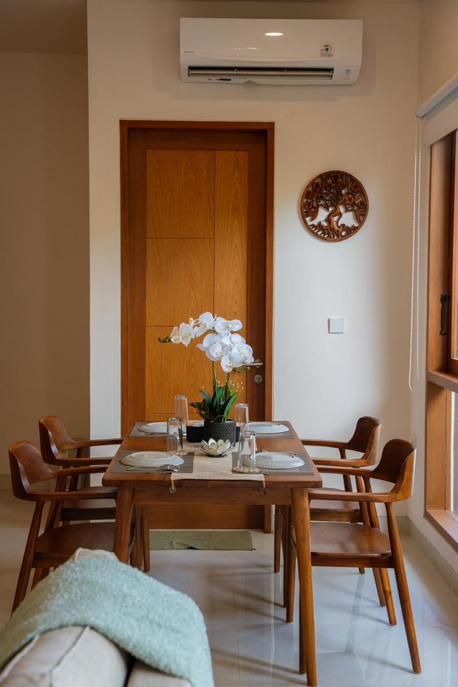 Teak dining table with orchids